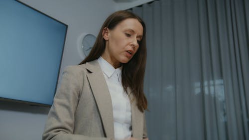 A Woman in Corporate Attire Talking and Doing Hand Gestures