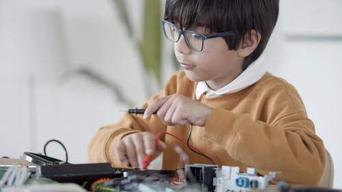 Boy Fixing Electronics