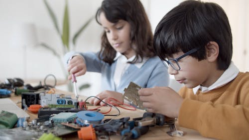 Boy and Girl Fixing Electronics