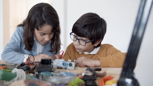 Boy and Girl Fixing Electronics