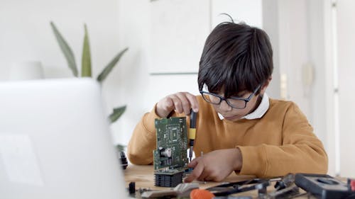 A Boy Fixing his Science Project