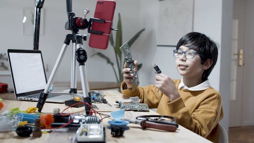 A Child Holding a Circuit Board