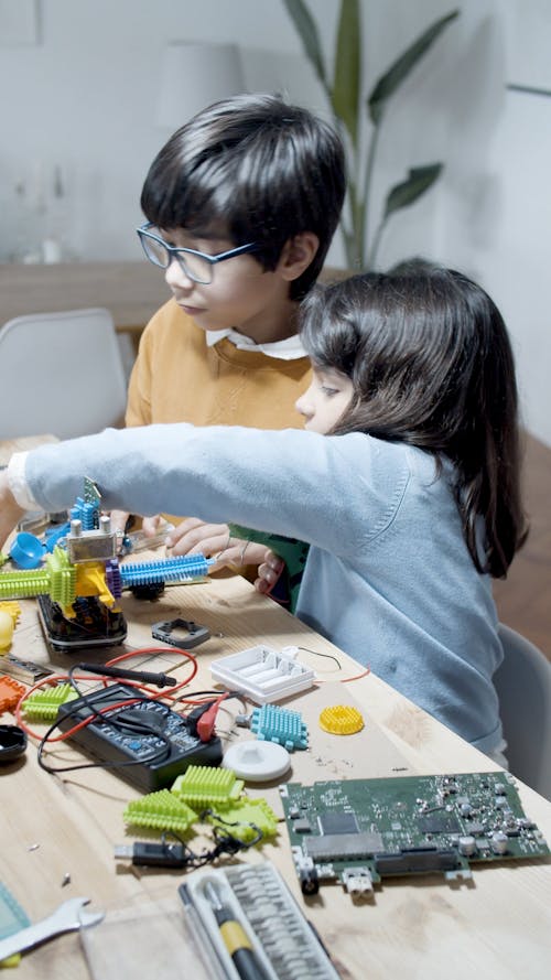 Girl and Boy Working with Hardware