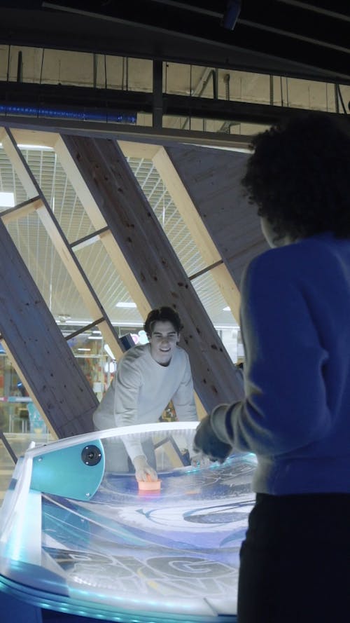 Friends Playing Air Hockey