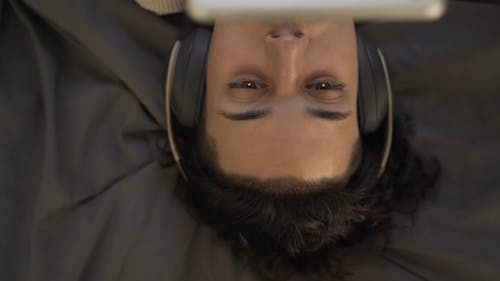 Close-Up View of a Person Listening to Music 