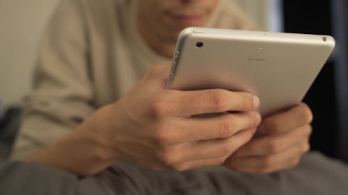 Close-Up View of a Person Using a Tablet