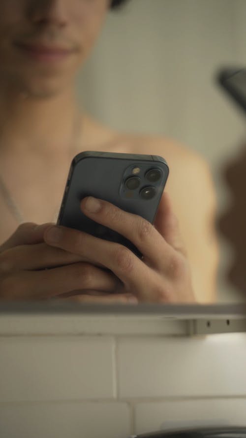 Close-Up View of a Person Using an Iphone