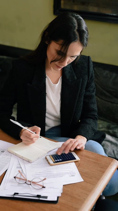 A Woman Calculating on Her Smartphone