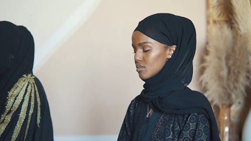 A Woman Praying while Wearing Hijab