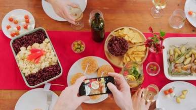 person taking a picture of the food on the table