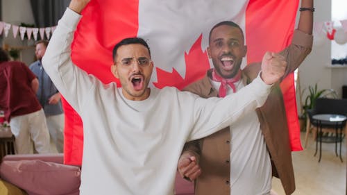 Men Cheering while Holding a Flag