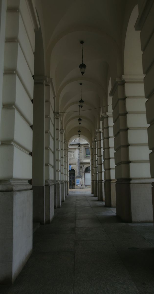 an empty narrow hallway of a building 7251759