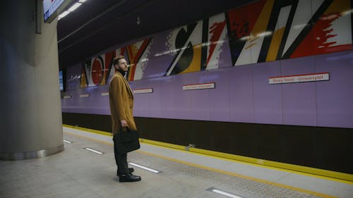 A Man Waiting for a Train to Arrive
