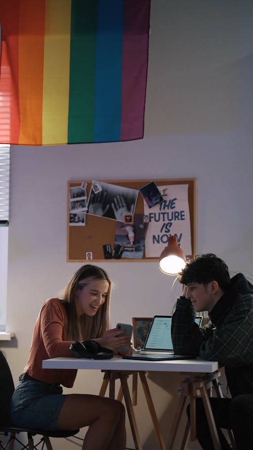 Coworkers Looking at a Smartphone Screen