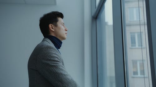 Man Looking Out the Glass Window 