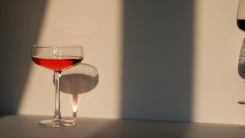 Person Putting Wine Glass on a Flat Surface