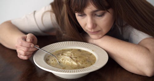  Depressed Woman with a Soup