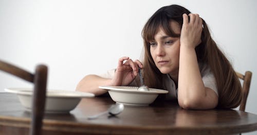 Footage of a Depressed Woman with a Food Plate