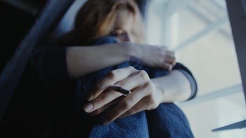 Emotional Woman Holding a Cigarette