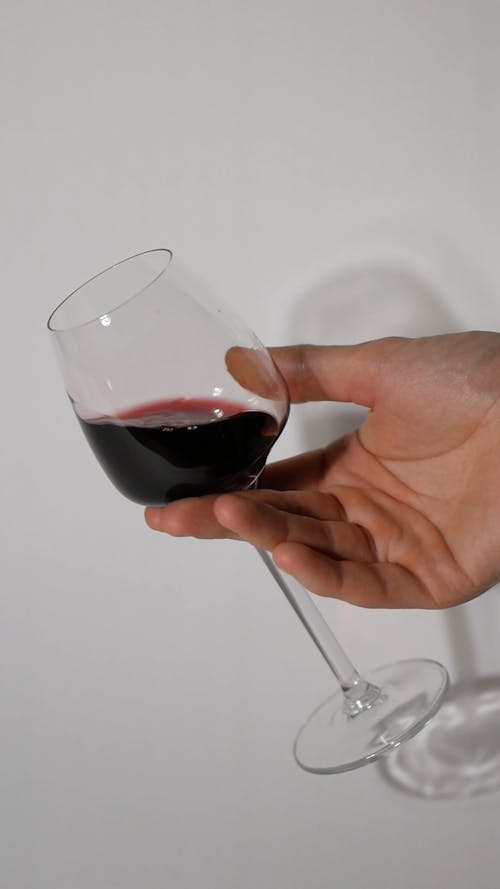 A Person Swirling Wine