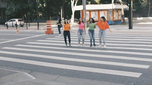 Women Dancing On a Pedestrian Lane