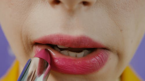 A Person Applying Lipstick