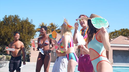 Group Of Friends Dancing In The Poolside