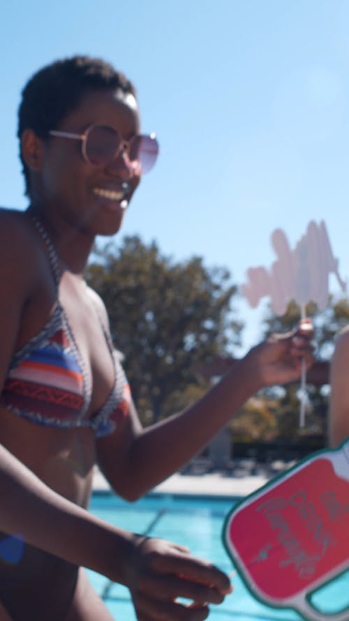 A Woman Dancing Outdoors By The Poolside 