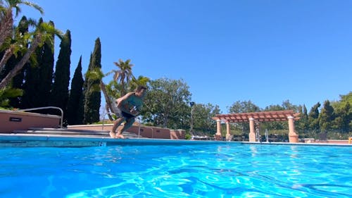 A Man Diving Into The Swimming Pool