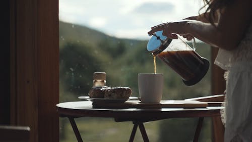 Person Pouring Coffee From French Press