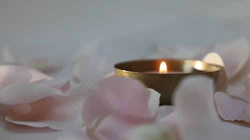 Close up of a Lighted Candle in a Bowl