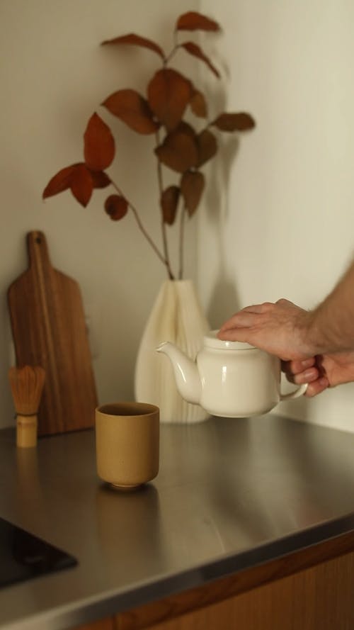 Pouring Tea On a Cup