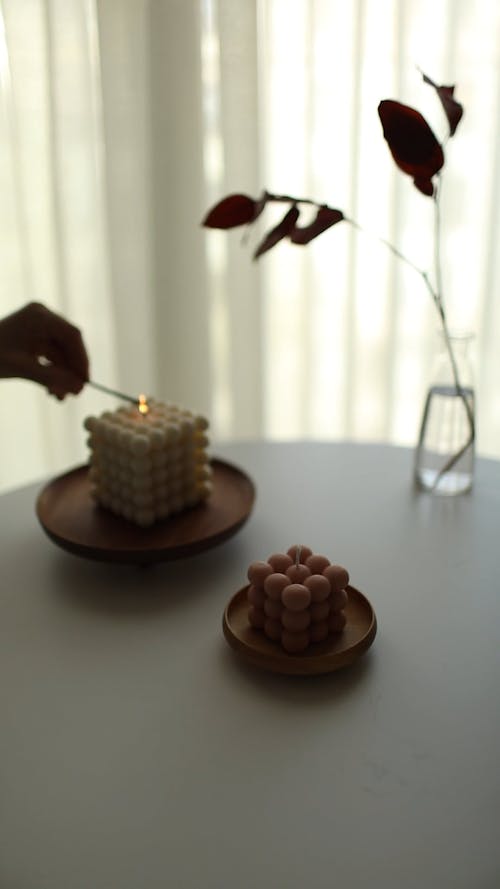 A Person Lighting Candles on a Table