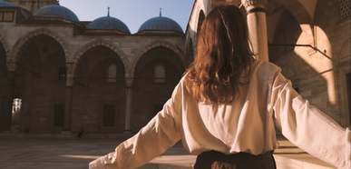 back view of a woman standing outside a moaque