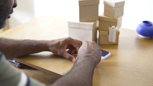 A Man Stamping a Tag