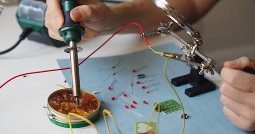 A Person using Soldering Iron