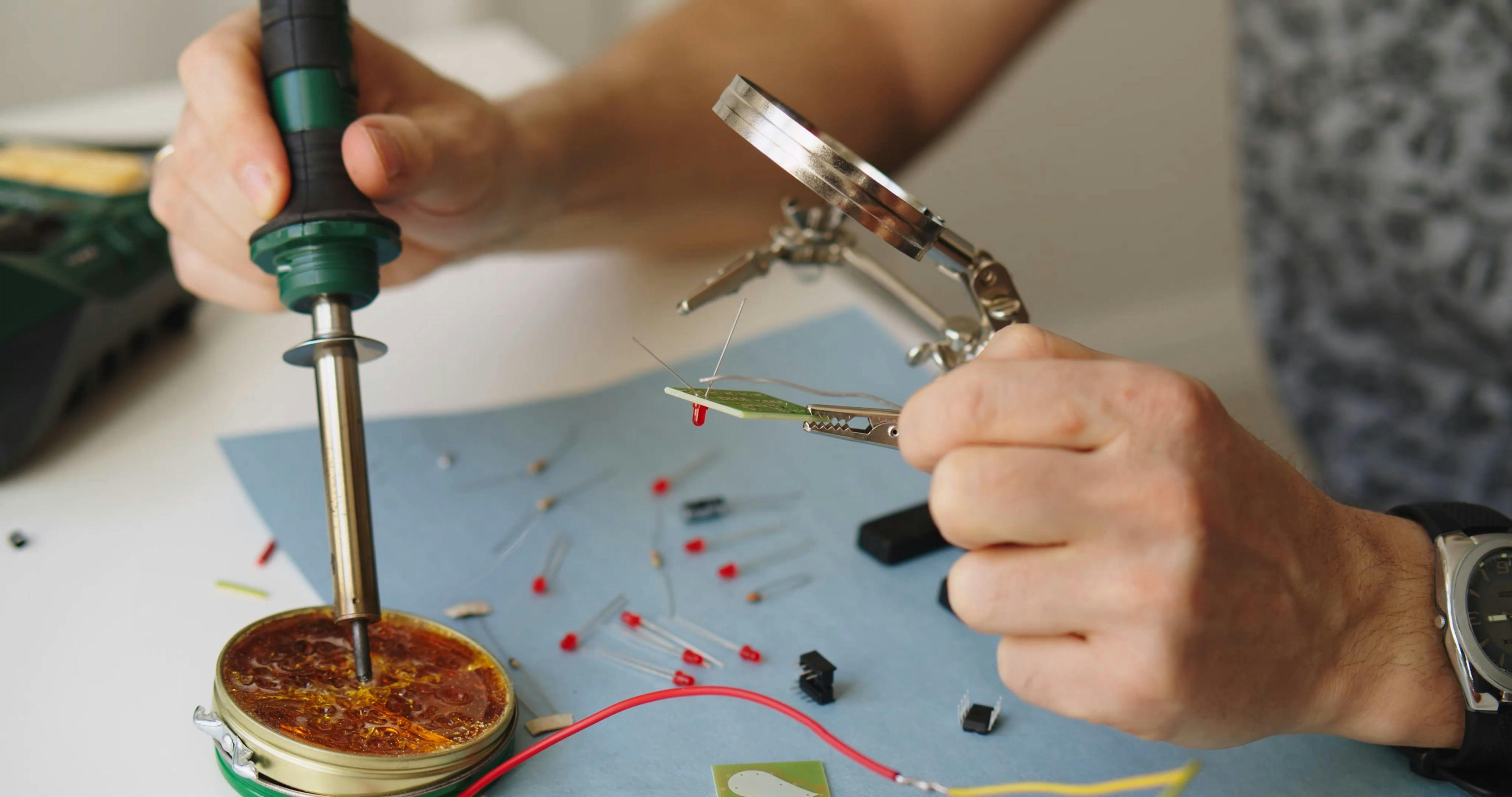 Person using Soldering Iron while Repairing Circuit Board · Free Stock Video
