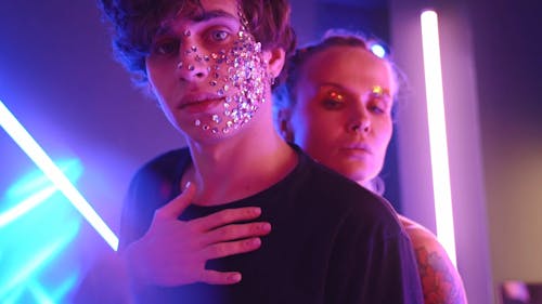 Couple With Glitters Hugging in a Room with Neon Lights