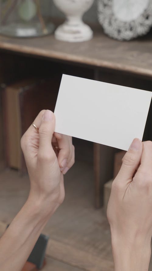 Person Holding a Blank Piece of Paper