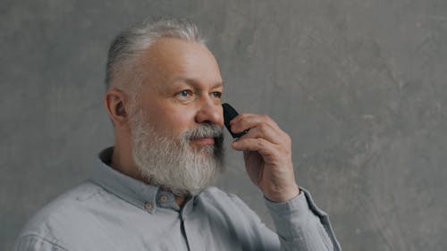 Elderly Man Combing His Beard