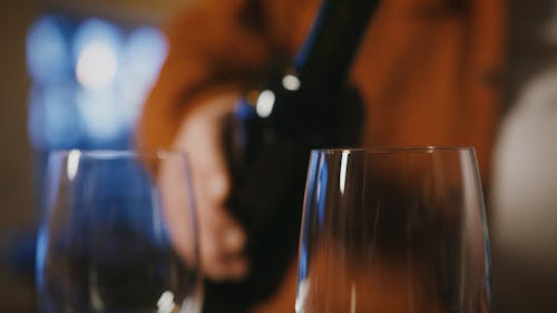 Person Pouring Red Wine