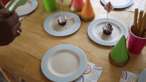 A Person Putting Utensils on Plates