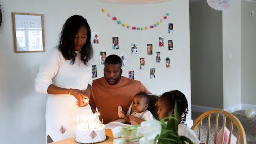 Woman Lighting the Candles on the Birthday Cake