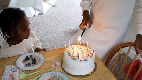 Person Lighting Birthday Candles