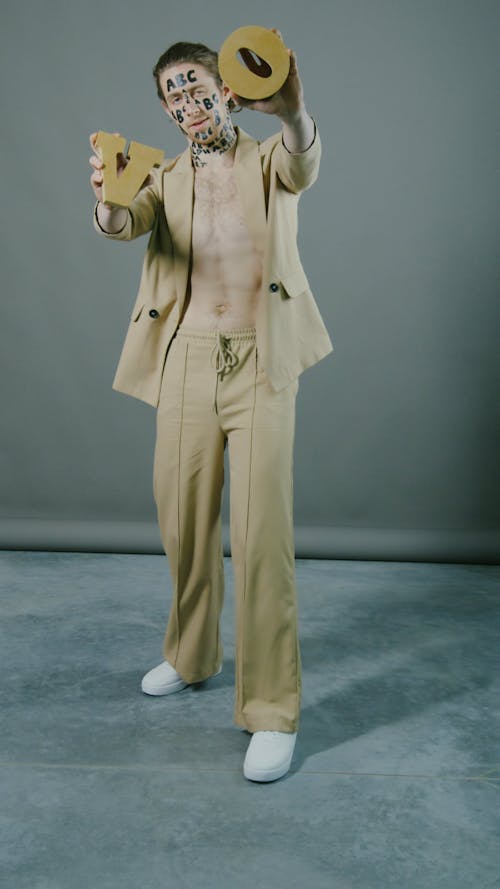 Young Male Model Posing with Plastic Letters
