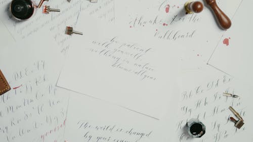 Overhead Shot of a Person Placing an Elbow Dip Pen on Papers