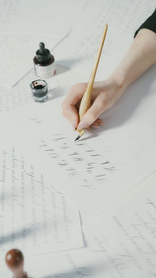 Person Writing using Pen and Ink