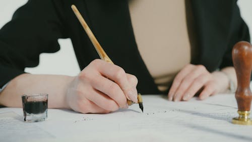 A Person Writing with an Elbow Dip Pen