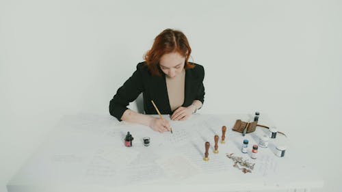 Woman Writing a Letter using Pen and Ink