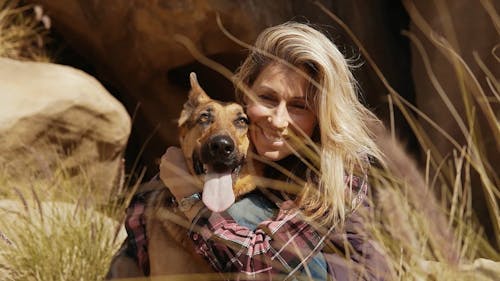 A Woman Cuddling a Pet Dog